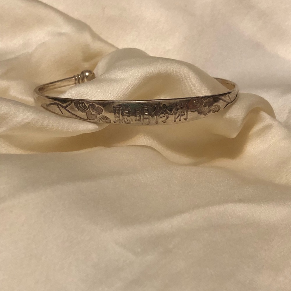 Adjustable silver Chinese bracelet.